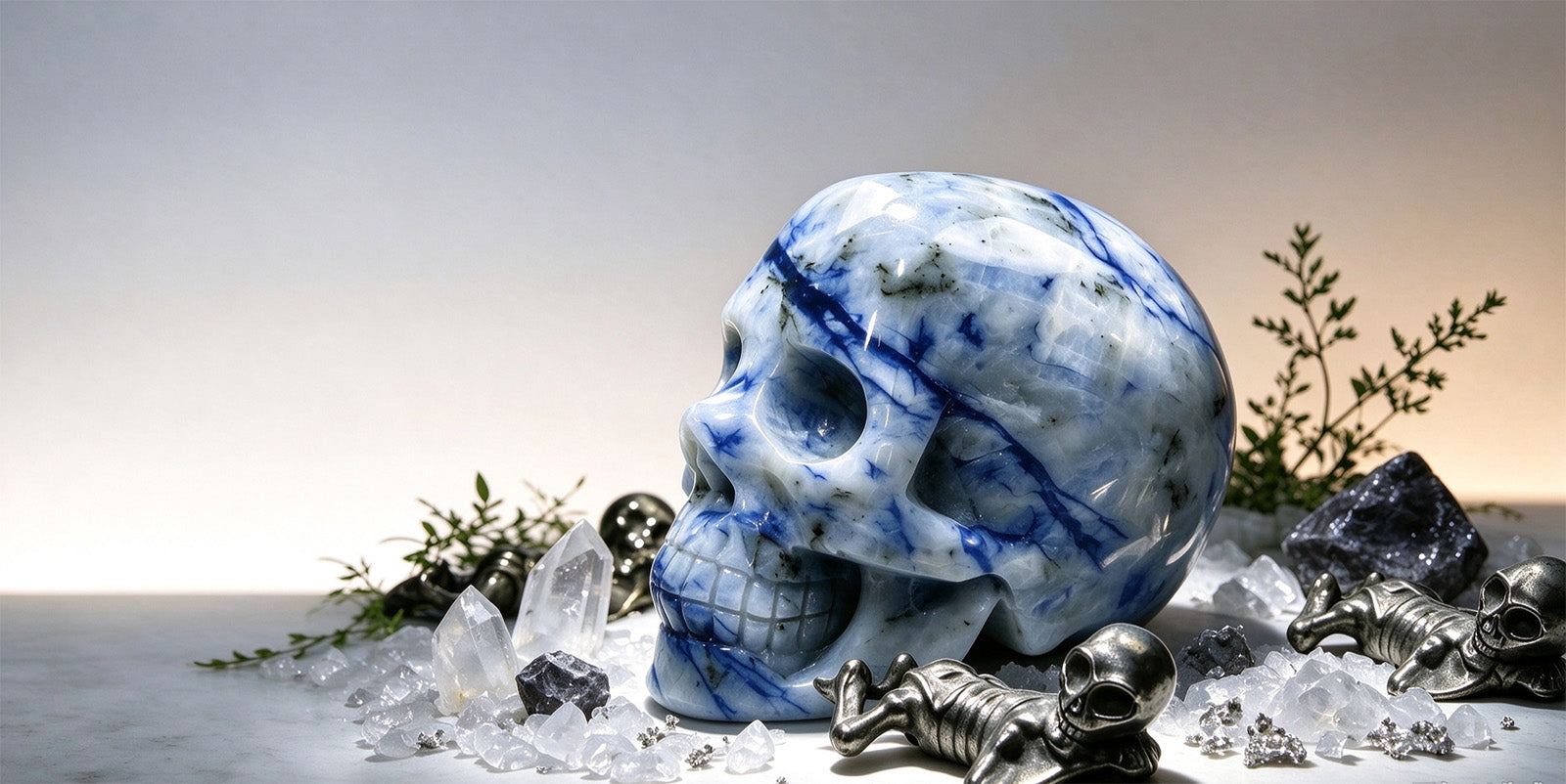 Large blue and white carved crystal skull with quartz points